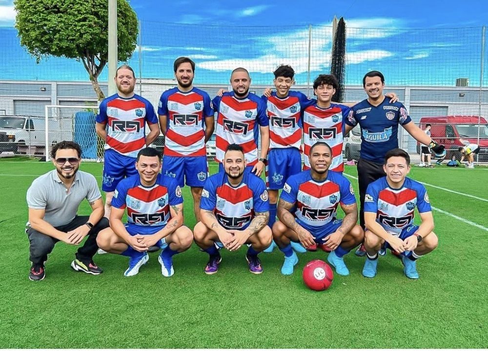 Jugadores del Famous United Soccer Club posan en una cancha de Miami con camisetas rojas, blancas y azules